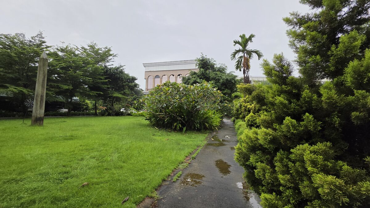 Wide lawn and garden path with the resort beyond
