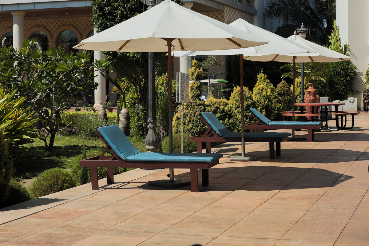 Sun loungers and umbrellas on the poolside deck