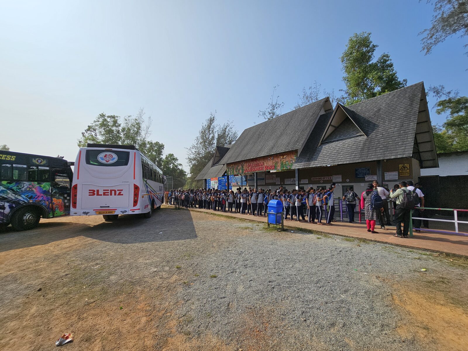 A school group arriving by bus and lining up at the entrance