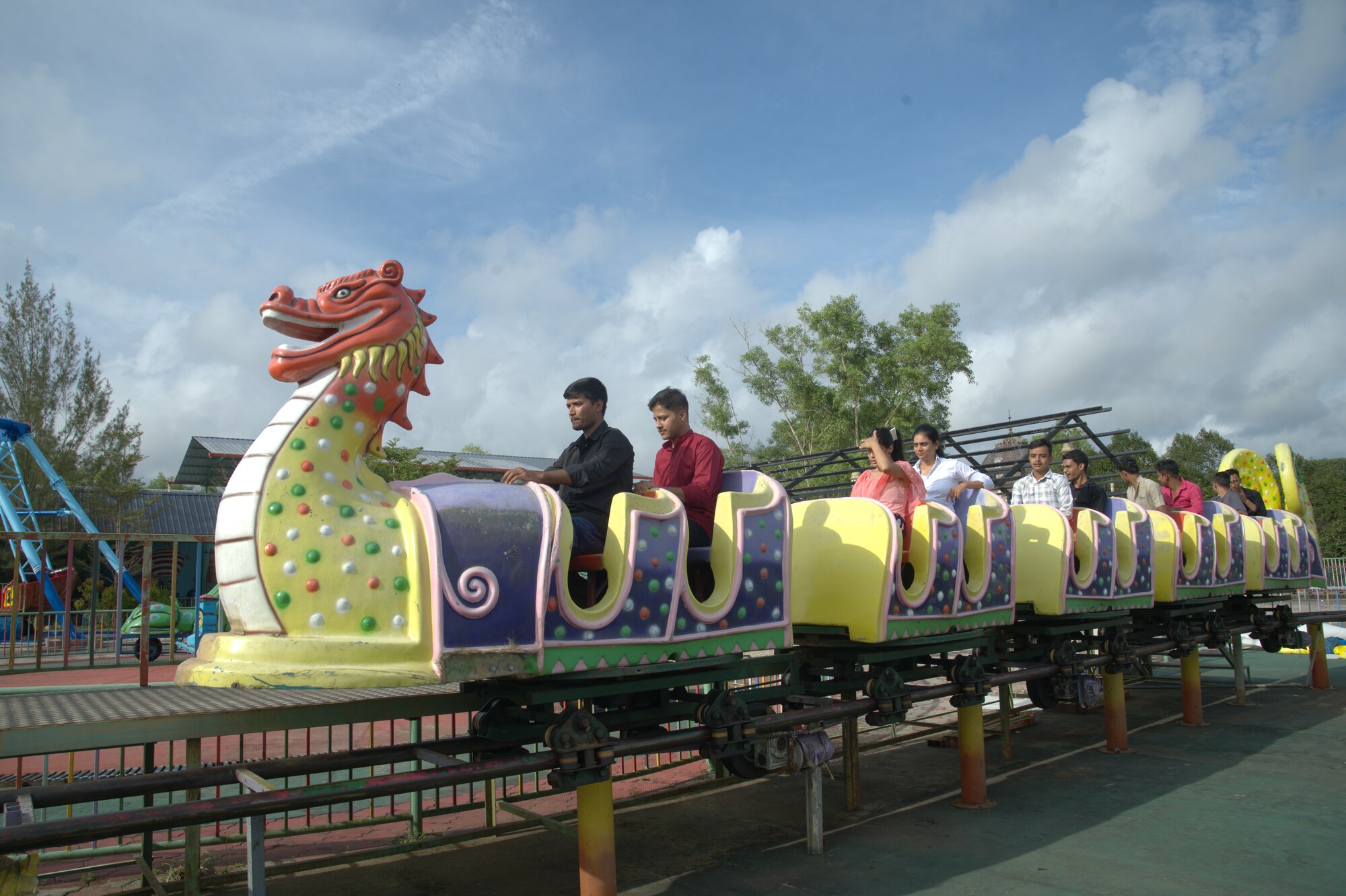 The dragon-themed coaster ride winding through the park with riders