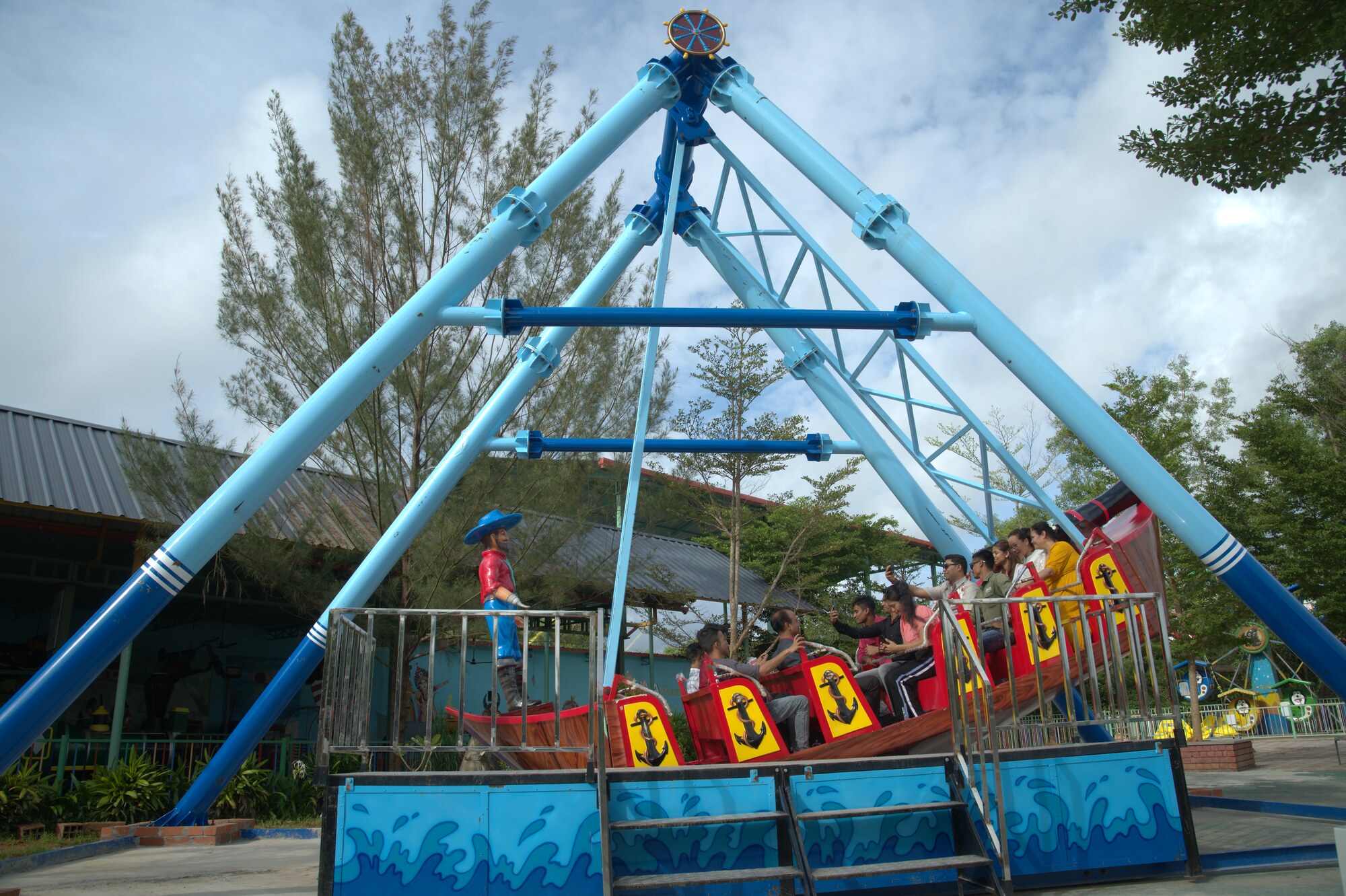 Riders swinging high on the pirate ship ride