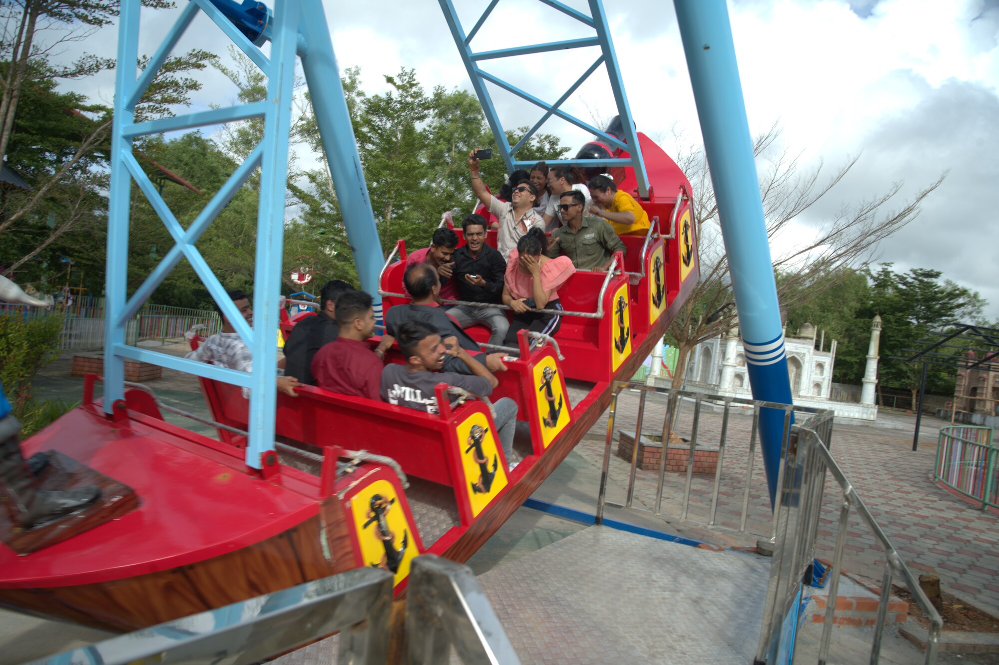 A group with hands up on a spinning boat ride