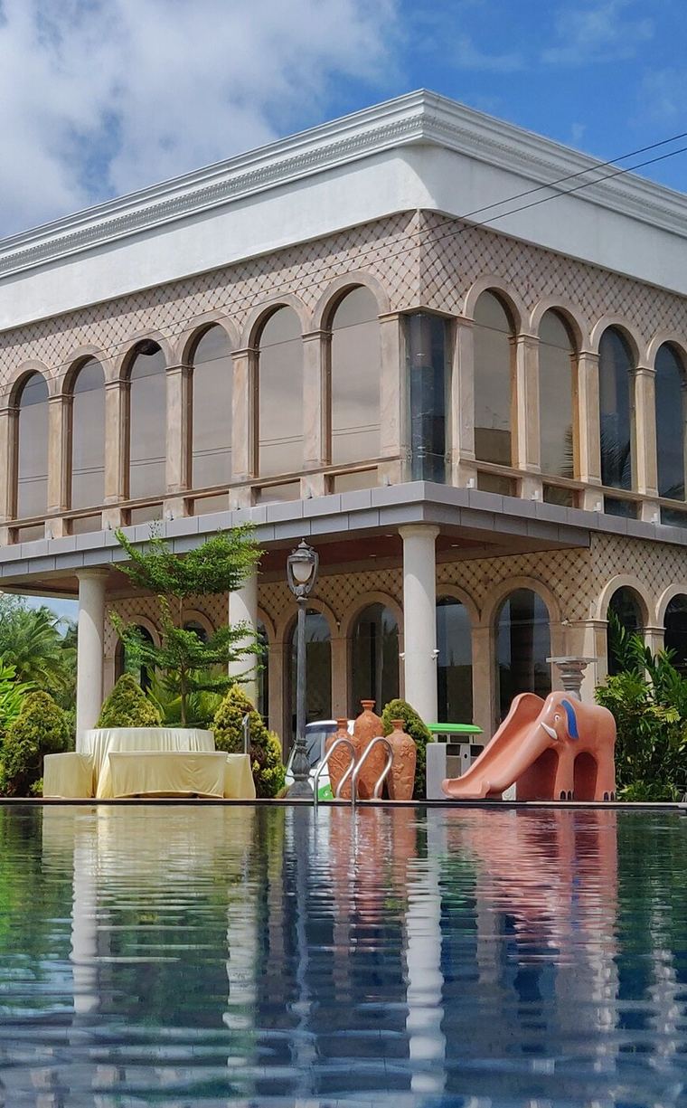 The main building reflected in the pool